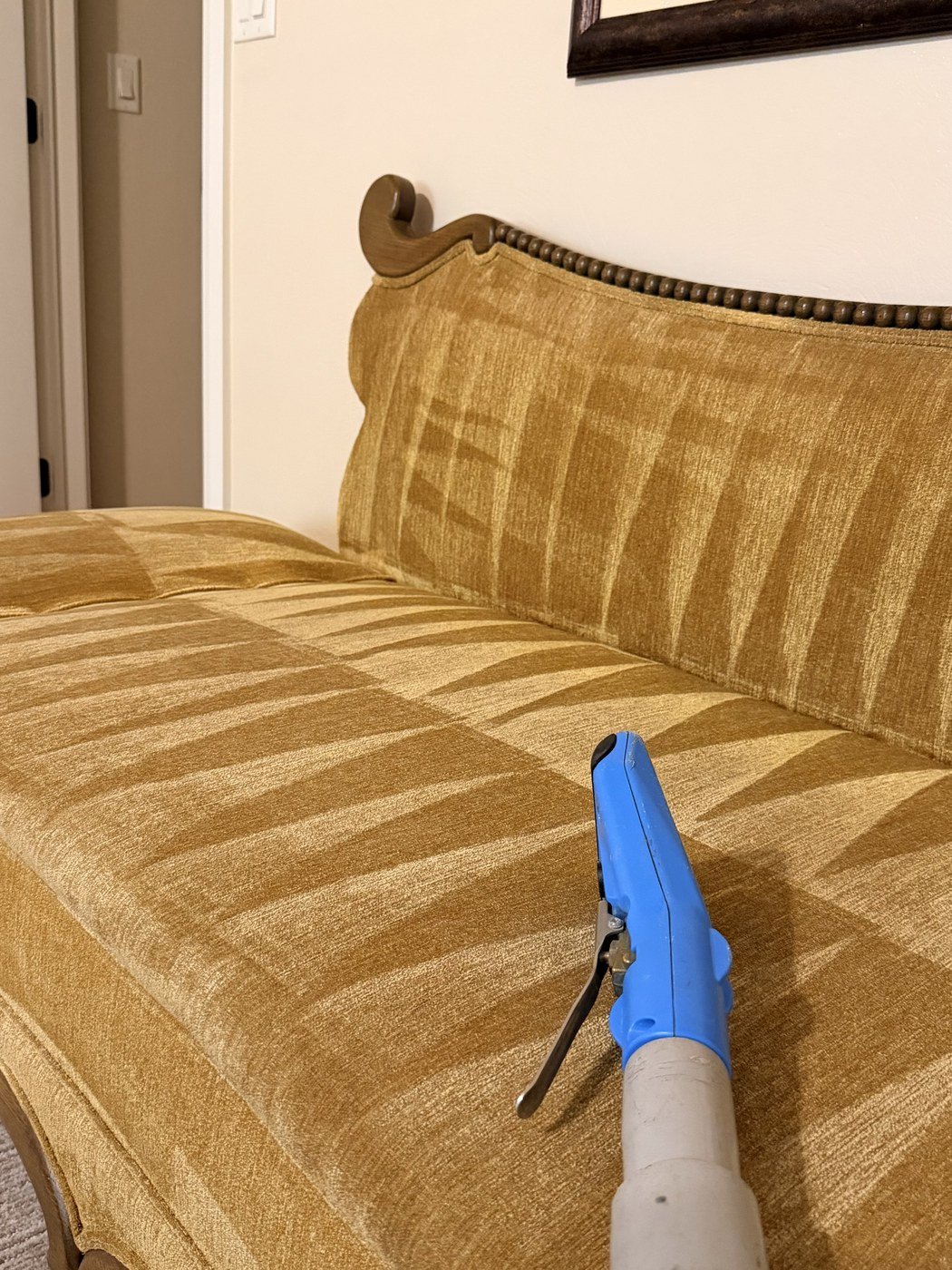 Upholstery cleaning wand treating a sofa cushion mid-clean, St. George, Utah